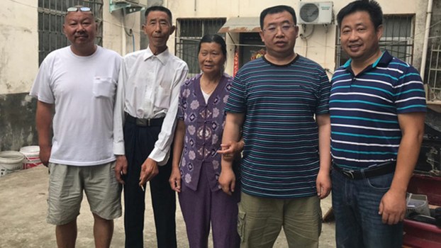 Human rights lawyer Xie Yang (right) visits fellow lawyer Jiang Tianyong (second from right) and his parents and the Jiang family home in Henan, where Jiang is under house arrest, June 25, 2019.
