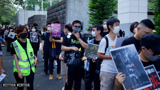 Marchers wear gas masks, as a sign of protest against Hong Kong police violence.