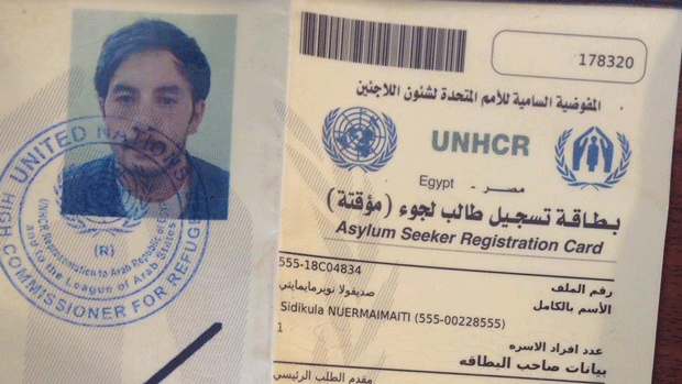 Sidiqulla Nurmemet s photo is shown on a UNHCR registration document