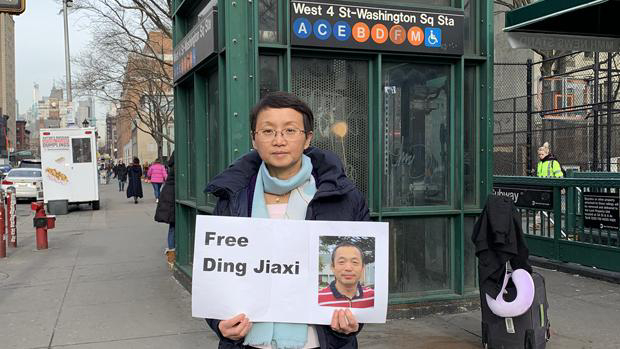 Luo Shengchun holds a sign on the streets of New York calling for Chinese authorities to release her husband from detention in this undated photo.
