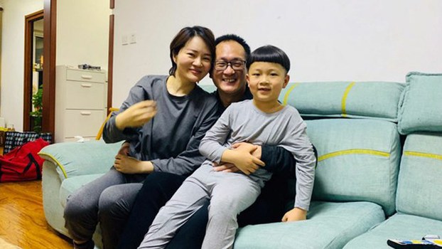Wang Quanzhang (C), his wife Li Wenzu (L), and the couple's young son Wang Guangwei smile in Beijing during their first family reunion since Wang was released from prison this month after serving five years, April 27, 2020.