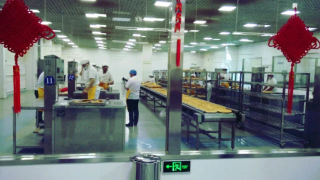 Uyghurs are making naan bread in the cultural-industrial park