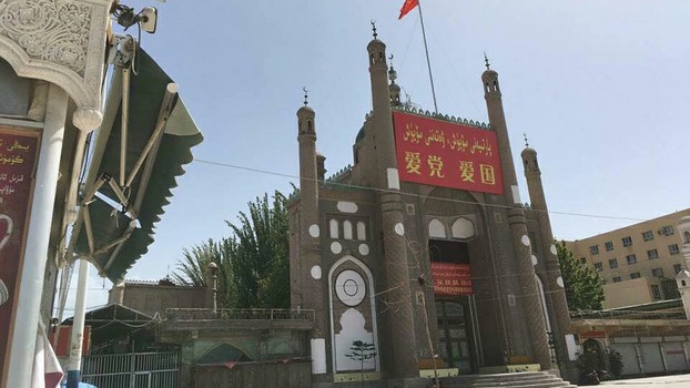 Jama Mosque adorned with China's flag and propaganda banners that read 'Love the Party, Love the Country' in Kashgar prefecture's Kargilik county, in an undated photo.